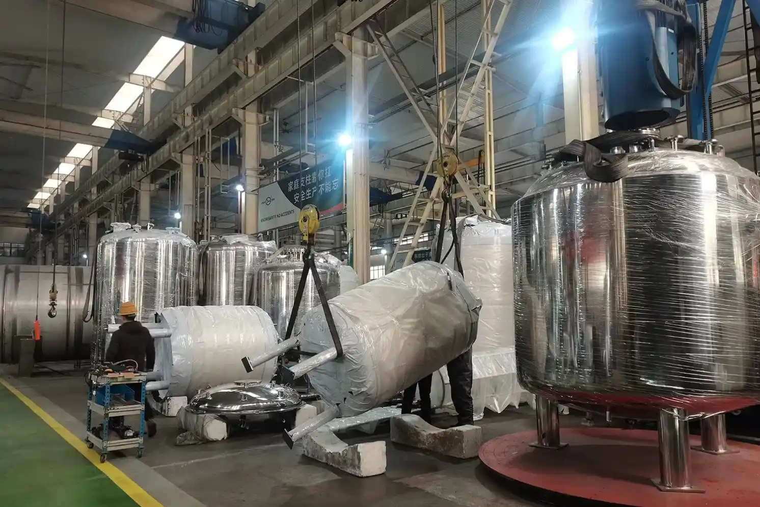 Skilled technician fabricating a custom industrial mixing tank